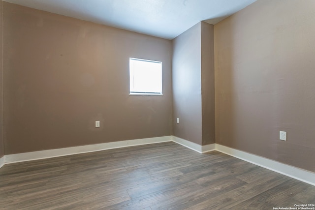 spare room with dark wood-type flooring