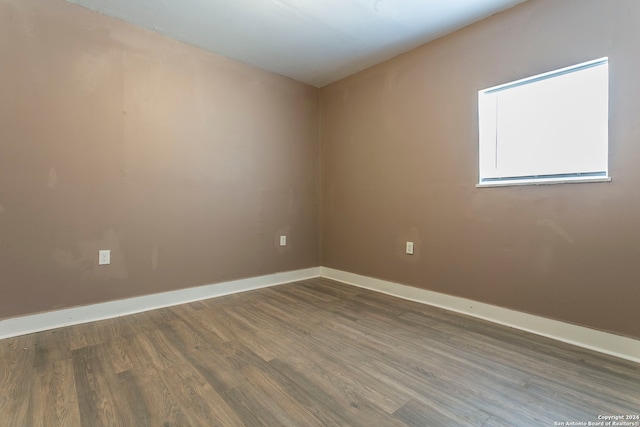 unfurnished room with hardwood / wood-style floors