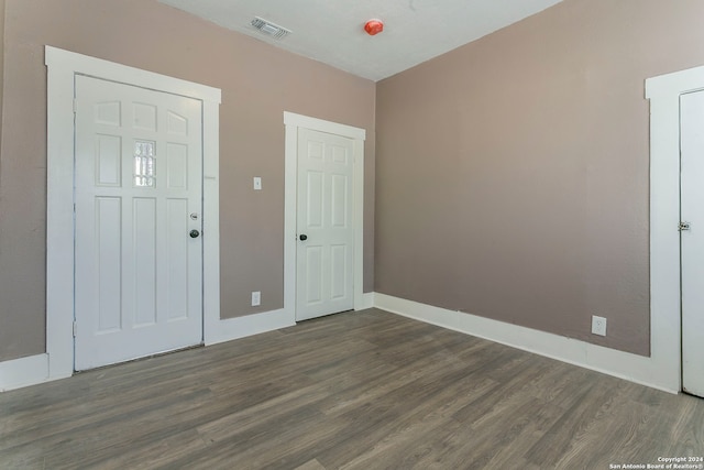 unfurnished bedroom featuring dark hardwood / wood-style flooring