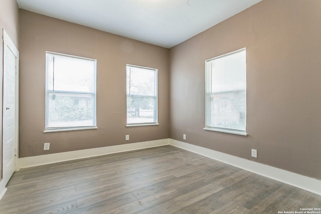 unfurnished room with wood-type flooring