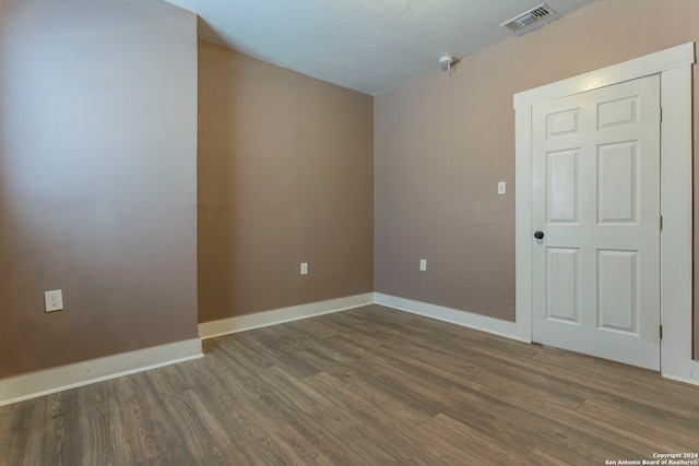 spare room featuring dark hardwood / wood-style flooring