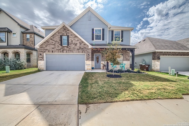 view of front of home featuring a garage and a front yard