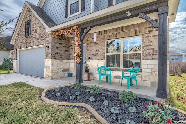 property entrance with a garage and a porch