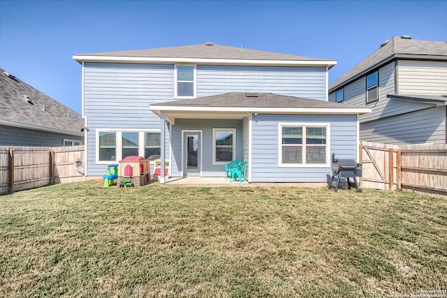 back of property featuring a lawn and a patio