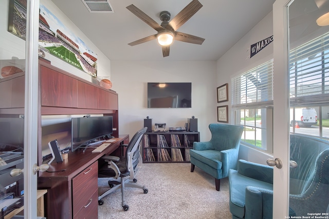 carpeted office featuring french doors and ceiling fan