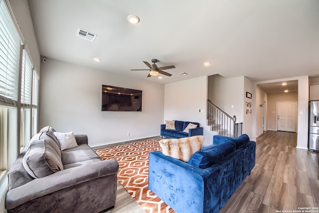 living room featuring hardwood / wood-style flooring and ceiling fan