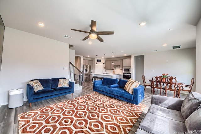 living room with hardwood / wood-style flooring and ceiling fan