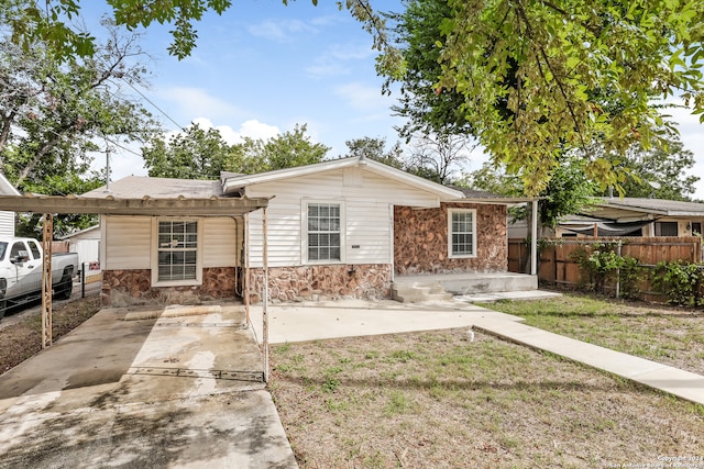 view of front of property with a patio area, a carport, and a front yard