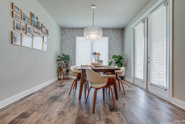 dining room with a notable chandelier and hardwood / wood-style flooring