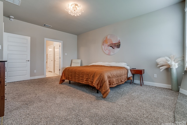 carpeted bedroom with ensuite bath