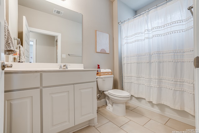 full bathroom featuring tile patterned flooring, vanity, toilet, and shower / tub combo