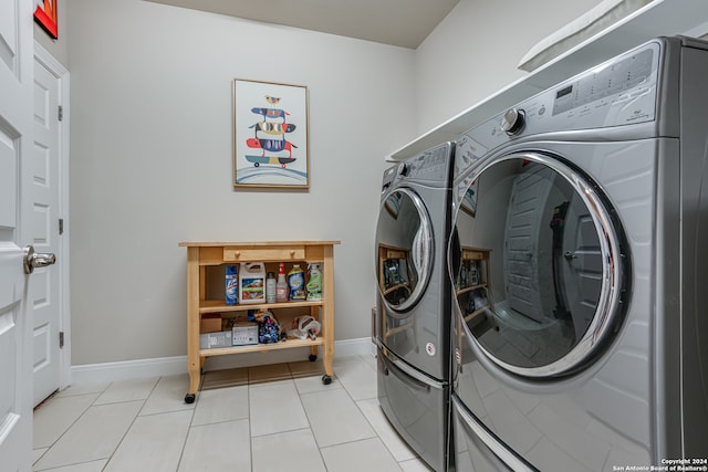 washroom with washer and dryer and light tile patterned floors