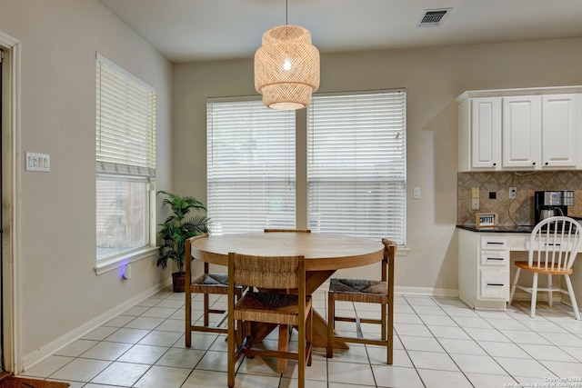 dining space featuring a wealth of natural light, a chandelier, and light tile patterned floors