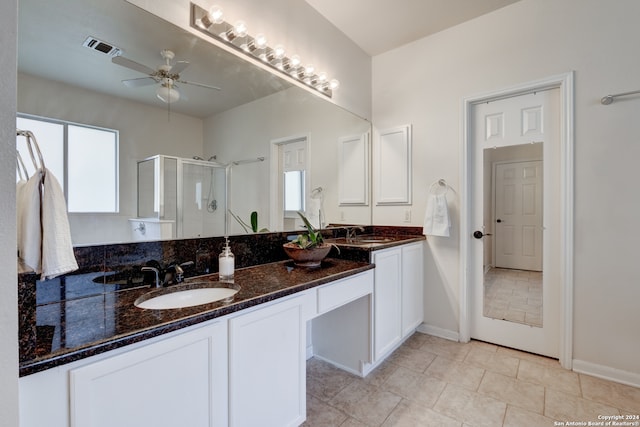 bathroom featuring walk in shower, tile patterned flooring, vanity, and a healthy amount of sunlight