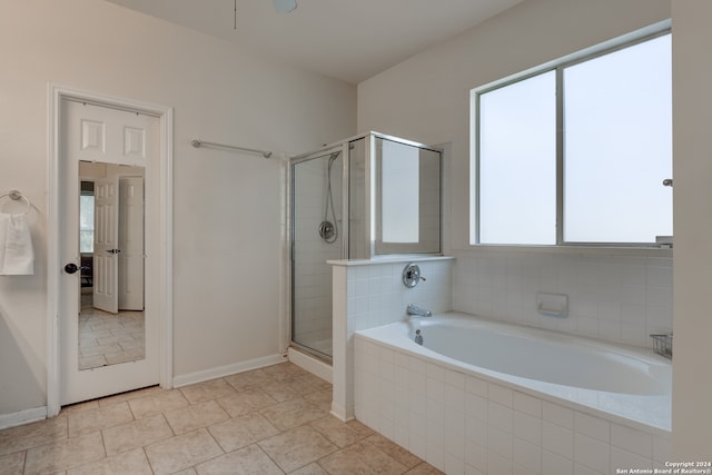 bathroom featuring tile patterned floors and separate shower and tub