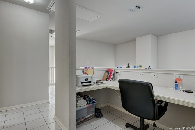 office area with built in desk and light tile patterned flooring