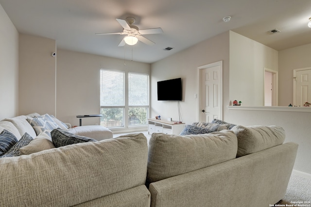 carpeted living room featuring ceiling fan