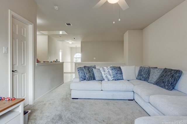 carpeted living room featuring ceiling fan