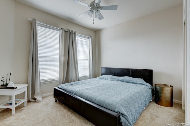 bedroom with ceiling fan and light carpet