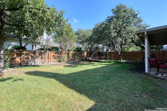 view of yard featuring a patio area and a trampoline