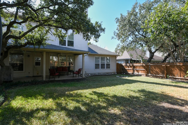 back of house with a yard and a patio area