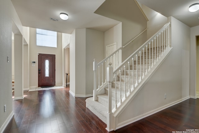 entryway featuring a high ceiling and dark hardwood / wood-style floors