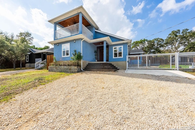 view of front of house featuring a balcony