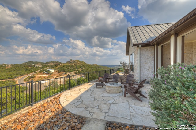 view of patio / terrace featuring a mountain view and a fire pit