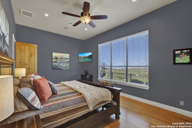 bedroom with ceiling fan and wood-type flooring