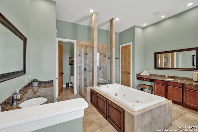 full bathroom with toilet, vanity, tile patterned floors, and independent shower and bath