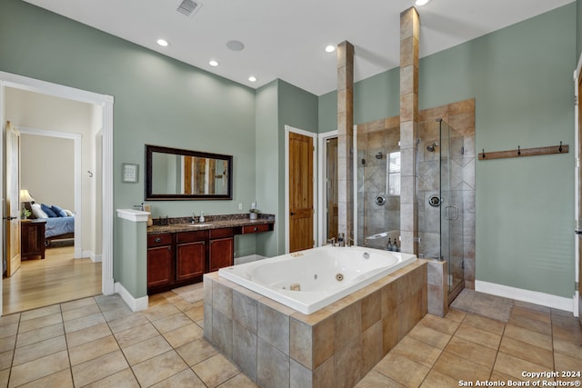 bathroom with vanity, independent shower and bath, and tile patterned flooring