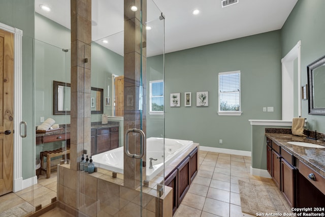 bathroom with tile patterned flooring, shower with separate bathtub, and vanity