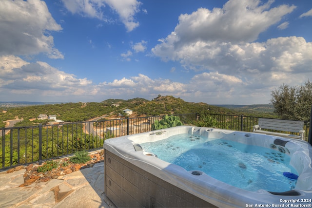 view of swimming pool featuring a hot tub