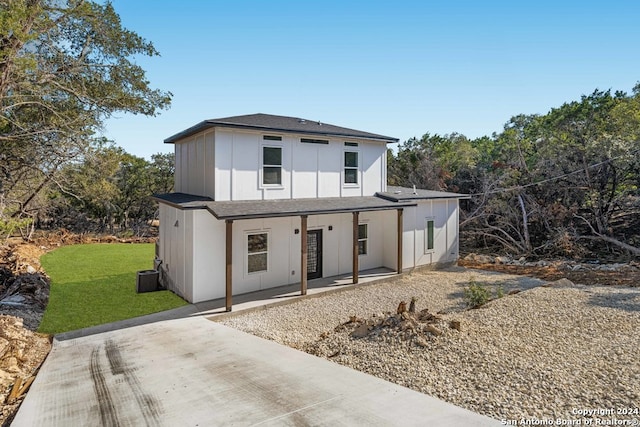 view of front of property with a front lawn and cooling unit