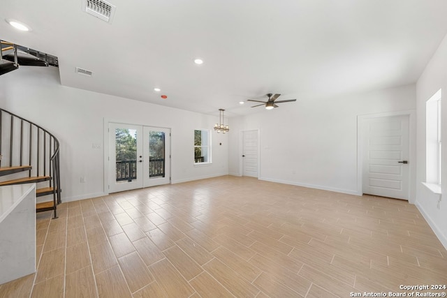 unfurnished living room featuring ceiling fan and french doors