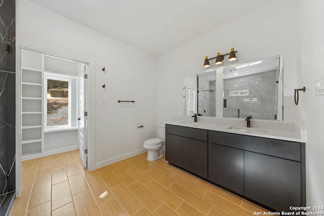 bathroom featuring walk in shower, vanity, and toilet