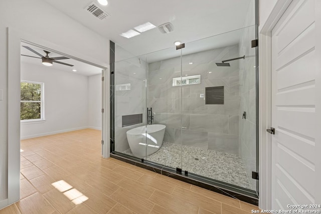 bathroom featuring ceiling fan and separate shower and tub