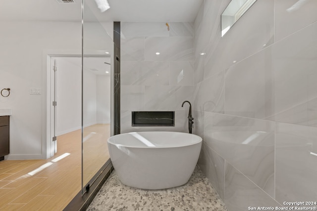 bathroom with vanity and a tub