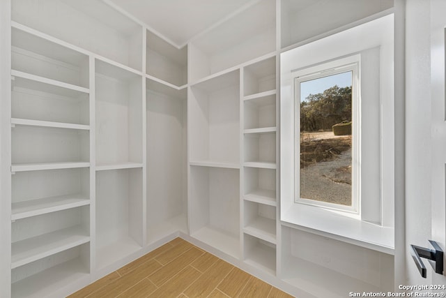 walk in closet featuring hardwood / wood-style floors