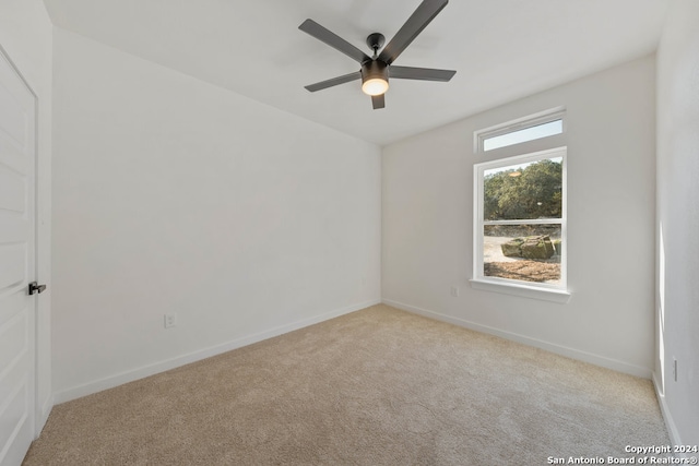 spare room featuring ceiling fan and light carpet