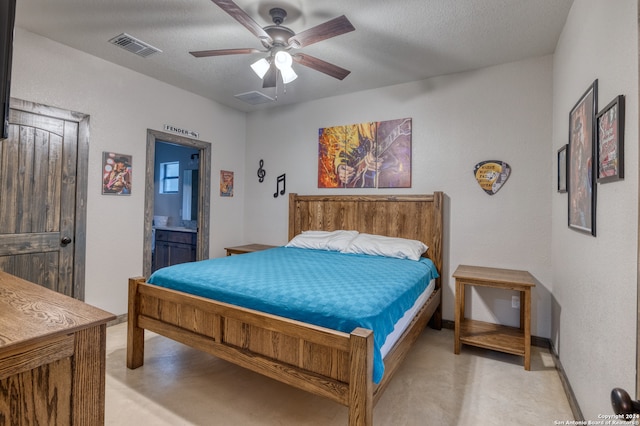 bedroom with ceiling fan, a textured ceiling, and ensuite bathroom