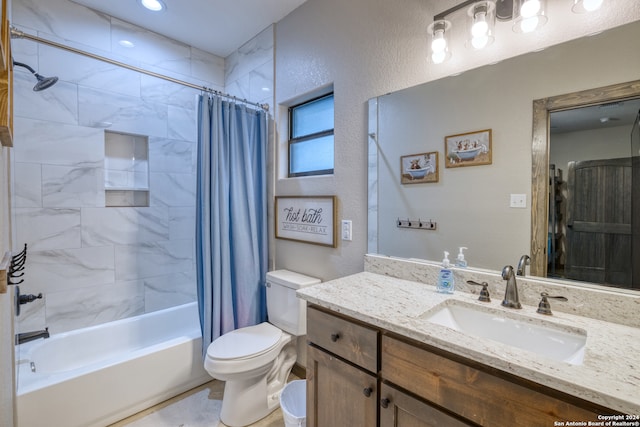 full bathroom with vanity, shower / tub combo, and toilet