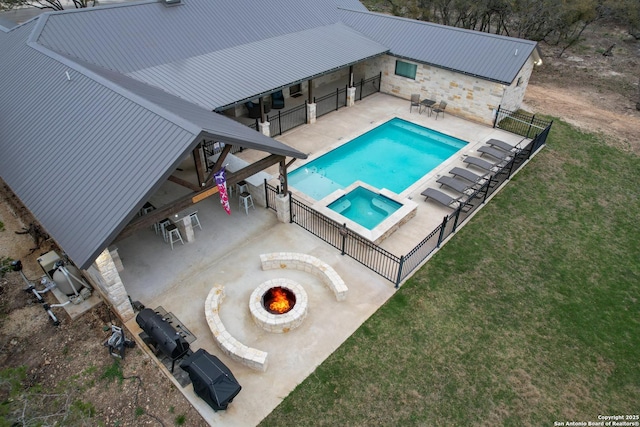 view of swimming pool with a yard, a patio, and an outdoor fire pit