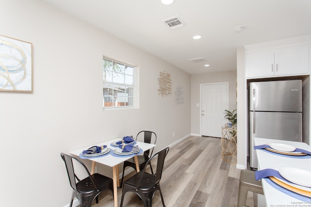 dining space with light hardwood / wood-style floors