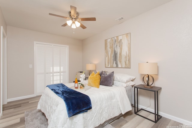 bedroom featuring a closet, ceiling fan, and light hardwood / wood-style flooring