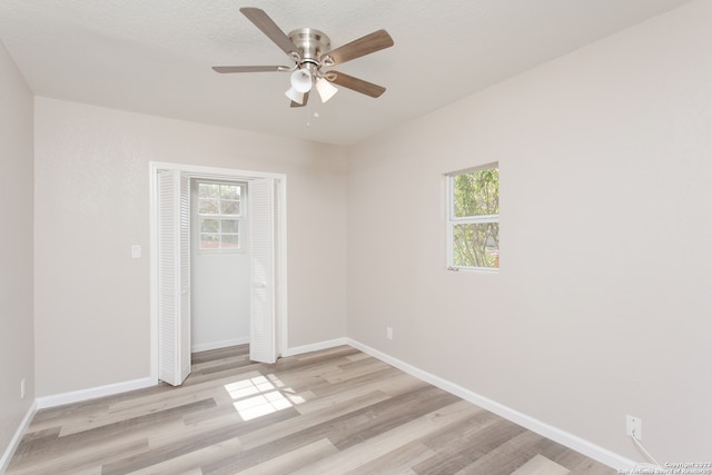 empty room with light hardwood / wood-style flooring and ceiling fan