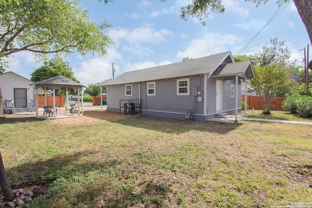 back of property with a patio, a yard, and a gazebo