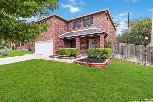 view of front of home with a front lawn and a garage