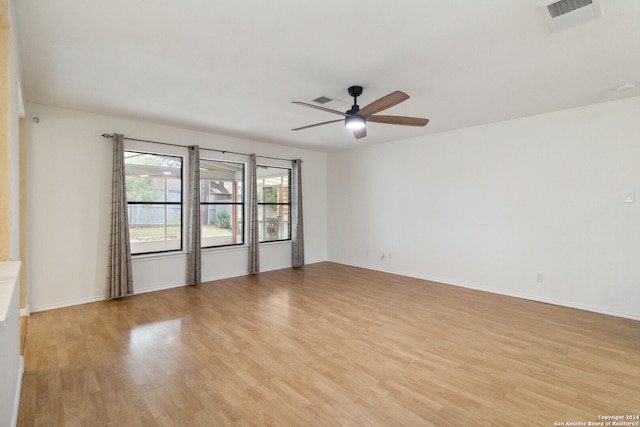 spare room with light wood-type flooring and ceiling fan