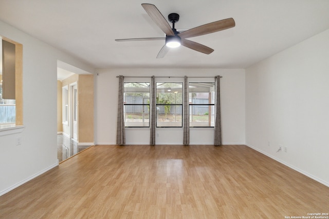 spare room with light wood-type flooring and ceiling fan